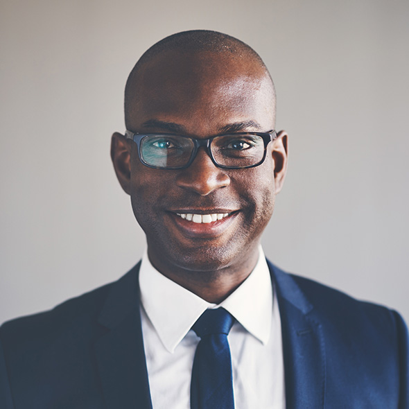 Betterdays Healthcare Confident professional in a suit smiling at the camera.